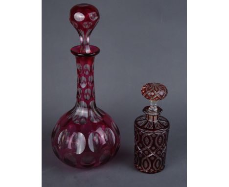19th/ early 20th Century cranberry cut glass decanter, H33.5cm and a 19th Century Bohemian ruby cut glass cylindrical decante