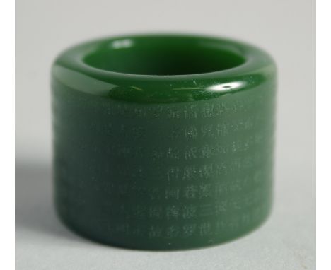 A CHINESE JADE ARCHER'S RING with calligraphy. 1.125ins.