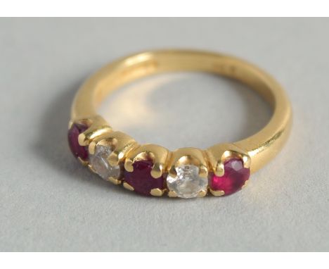 AN 18CT GOLD, DIAMOND AND RUBY RING.