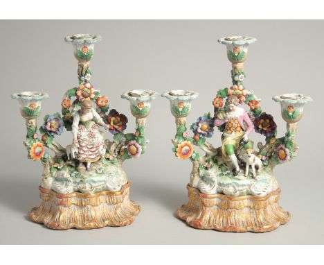 A VERY GOOD PAIR OF SAMSON CHELSEA DERBY PORCELAIN CANDLESTICK GROUPS. a woman with a lamb, a man with a dog, bocage back wit