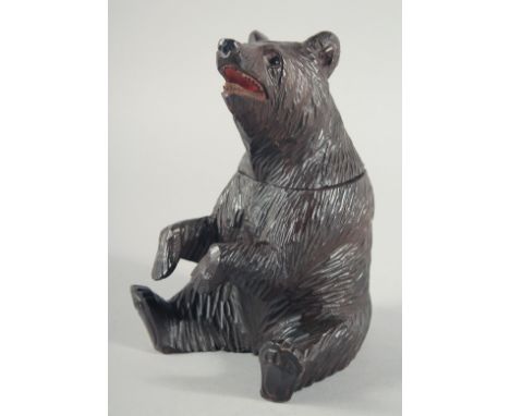 A NICE BLACK FOREST CARVED BEAR CADDY with hinged head. 8ins high.