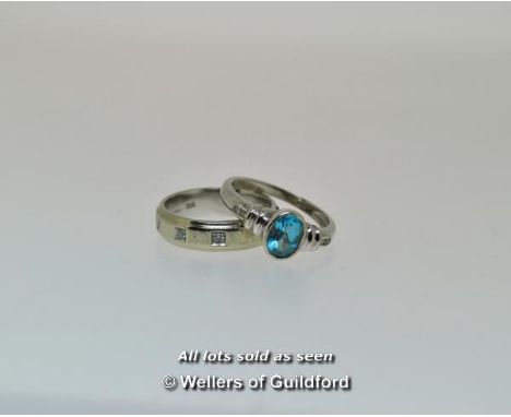 Blue topaz ring, oval cut blue topaz rubover set in 9ct white gold, with two small diamonds set to each shoulder, gross weigh