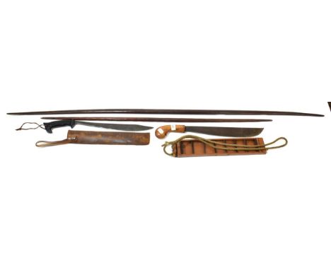 An Indonesian Klewang, the 40cm straight back steel blade with broad curved edge, wood pistol grip and one sided wood scabbar