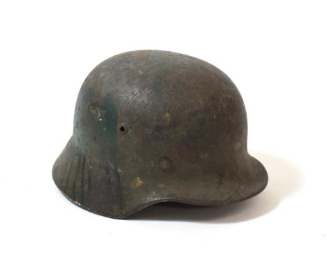A German Third Reich M35 Single Decal Army Combat Helmet, bearing traces of later green paint, the the left side with Wehrmac