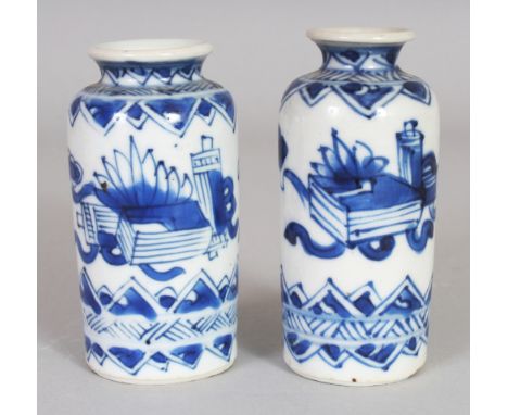 A GOOD SMALL PAIR OF CHINESE KANGXI PERIOD BLUE & WHITE PORCELAIN VASES, each painted with objects and ribboned emblems, 3.1i