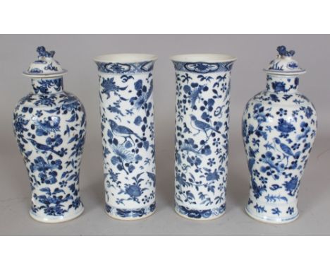 A GARNITURE OF FOUR 19TH CENTURY CHINESE BLUE & WHITE PORCELAIN VASES, two with covers, each painted with birds, butterflies,