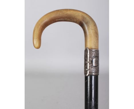 A HORN HANDLED WOOD WALKING STICK, with an unmarked embossed silver collar, the horn possibly rhinoceros horn, 32.75in long, 