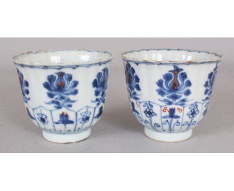 A PAIR OF EARLY 18TH CENTURY CHINESE KANGXI PERIOD UNDERGLAZE-BLUE & IRON-RED DECORATED FLUTED PORCELAIN BEAKERS, each base w