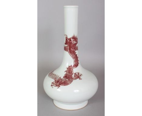 A CHINESE UNDERGLAZE COPPER RED PORCELAIN DRAGON BOTTLE VASE, the base with a six-character Kangxi mark, 11in high.