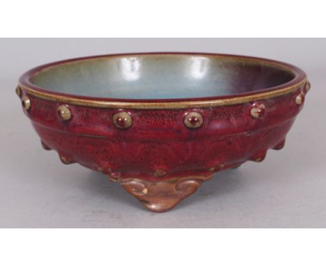A CHINESE JUN WARE PURPLE SPLASH CERAMIC TRIPOD BOWL, supported on three ruyi-form feet, 7in diameter at rim & 2.8in high.