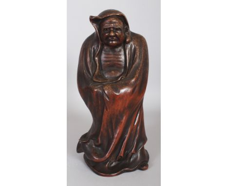 AN EARLY 20TH CENTURY JAPANESE BIZEN TYPE CERAMIC FIGURE OF DARUMA, standing in a hooded robe, 13.5in high.