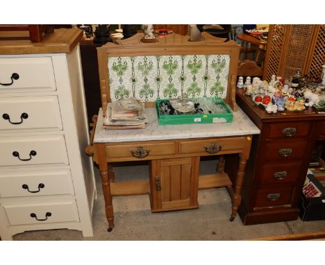 A light wood marble top washstand with tile back