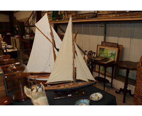 A model boat on wooden plinth 