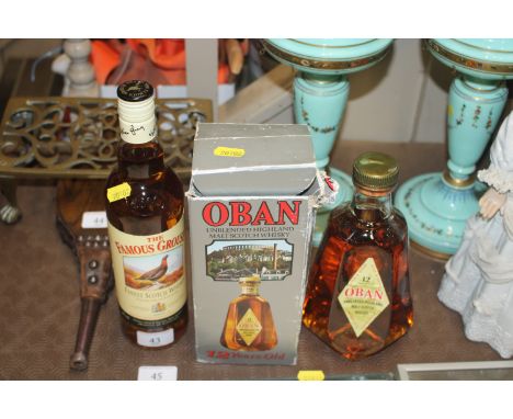 A bottle of Oban 12 Year Old Unblended Highland Malt Scotch Whisky and a bottle of Grouse whisky