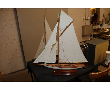 A model boat on wooden plinth 