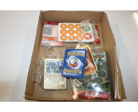 A box containing Pokemon Diamond and Pearl cards including Glitter Rampardos card 