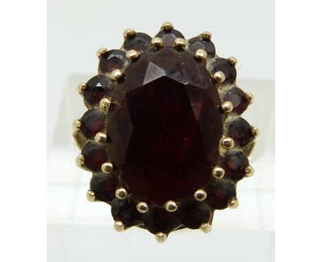 A 9ct gold ring set with garnets in a cluster (size K)