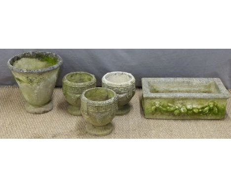 Three matching garden planters or pots with Greek key design, larger planter and a rectangular trough, length 58cm