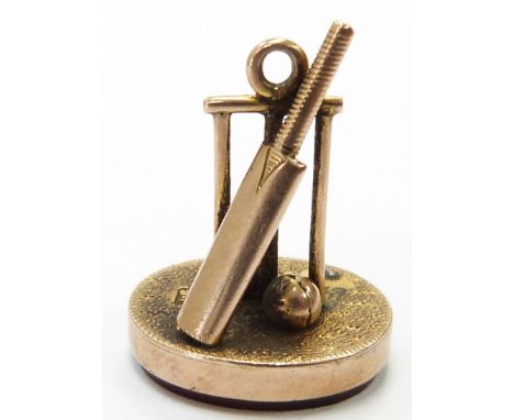 A 9ct gold fob with cricket bat, balls and stumps&nbsp;