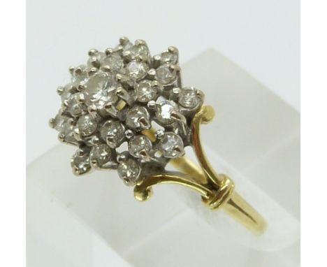 An 18ct gold ring set with diamonds in a cluster (size Q)