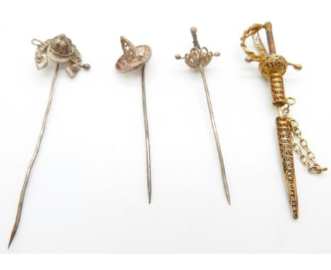 Four filigree stick pins, one in the form of a horseshoe and whip, two swords and a hat