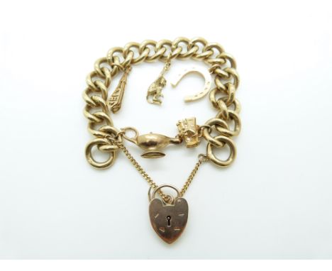 A 9ct gold curb link bracelet with five charms including a horseshoe, lamp and monkey, 74g