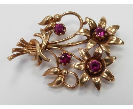 A 9ct gold brooch in the form of a bunch of flowers set with four synthetic rubies, 7.9g, width 5.5cm x length 4cm&nbsp;