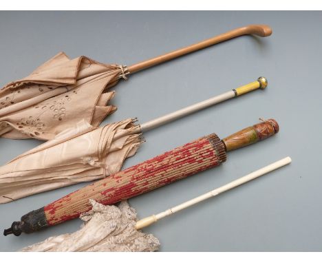 Four parasols including guilloche enamel handled example surmounted by a rose cut diamond of approximately 0.2ct, having Russ