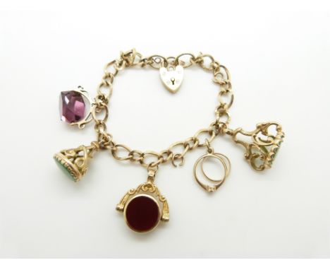 A 9ct gold charm bracelet with two 9ct gold fobs, two 9ct gold swivel fob charms and a ring charm, 30.8g