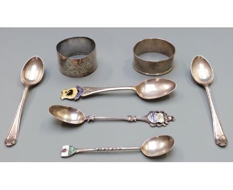 Two hallmarked silver napkin rings and five various hallmarked silver spoons, some with enamel decoration, weight 91g