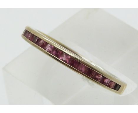 A 9ct gold eternity ring set with garnets (size O)