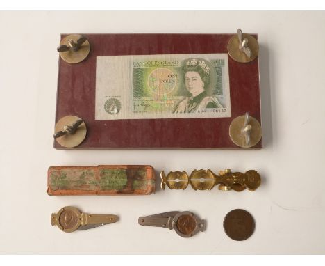 A set of brass sovereign scales, Victorian spy penny, banknote press etc