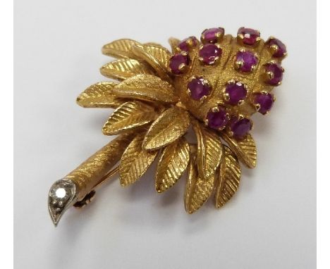An 18ct gold brooch in the form of a stylised palm tree set with rubies with a diamond to the stem by J.Rossi, 10g,width 4cm 