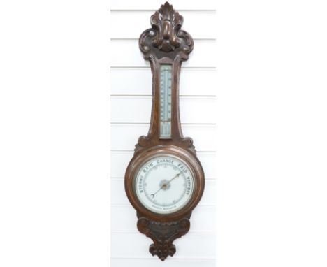 A early 20thC carved oak aneroid barometer, the white enamelled dial with bold black predictions, 90cm tall&nbsp;&nbsp;