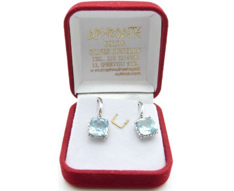 A pair of 18ct white gold earrings each set with a mixed cushion cut aquamarine measuring approximately 3ct surrounded by dia