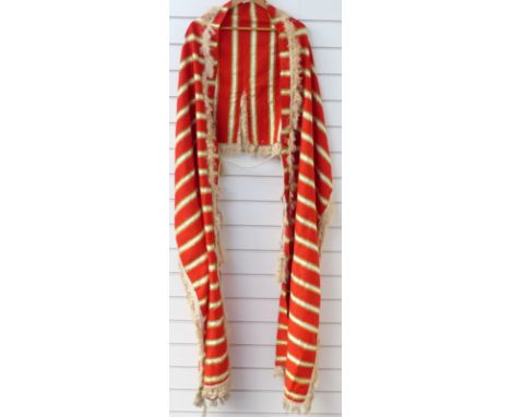 A striped cloak style garment with fringed braid and tassel trim&nbsp;