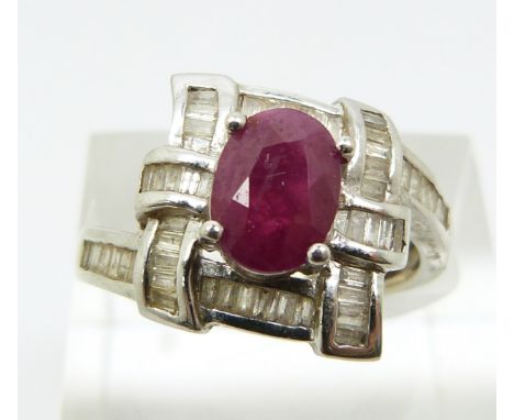 A 14k white gold ring set with a ruby and diamonds, total diamond weight approximately 0.32ct (size O)