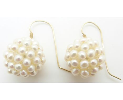 A pair of earrings set with pearls in clusters with 14k gold fittings&nbsp;