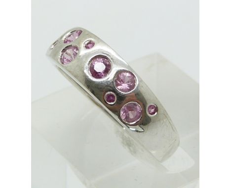A 9ct gold ring set with round cut pink sapphires (size P)