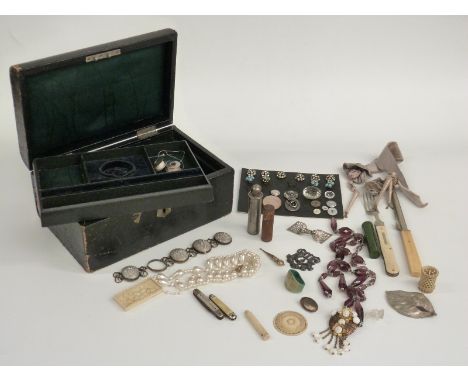 A collection of jewellery including an Art Deco scarf ring, carved ivory box, Victorian gold plated charm, beads, buttons, a 