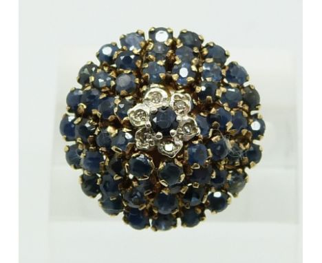 A 9ct gold ring set with sapphires and diamonds in a large cluster (size O)