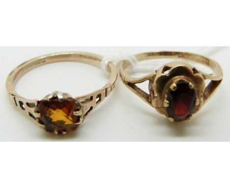 A 9ct gold ring set with a citrine and a 9ct gold ring set with a garnet&nbsp;