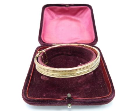 A 9ct rose gold bangle in original box, 8.9g