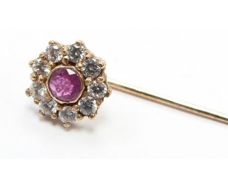A 9ct gold stick pin set with a ruby and cubic zirconia
