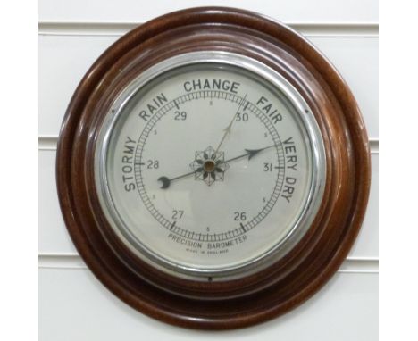 A circular mahogany aneroid barometer