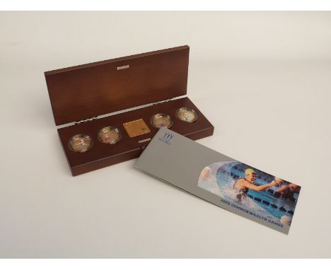 Royal Mint official Commonwealth Games silver piedfort collection 2012, comprising four gold and enamelled coins and an ingot