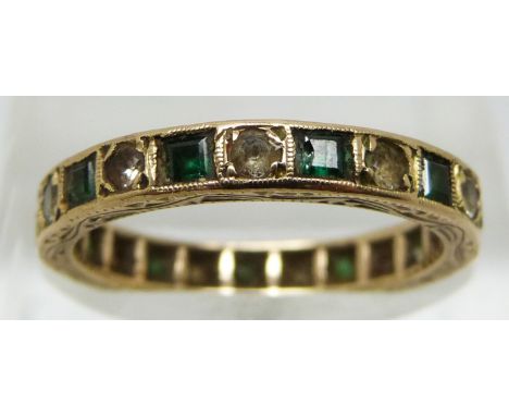 A 9ct gold eternity ring set with alternating green and clear paste, 2.4g (size M)