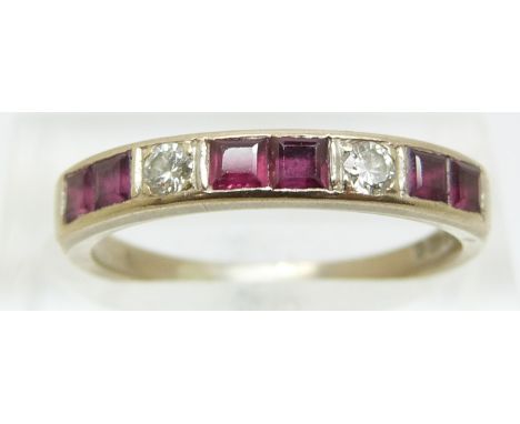 An 18ct gold ring set with square cut rubies and two round cut diamonds, size O