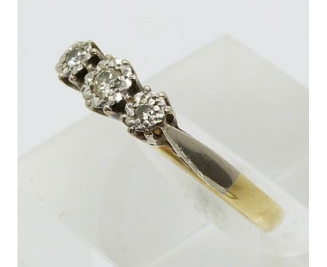 An 18ct gold ring set with three diamonds in a platinum setting (size L)&nbsp;