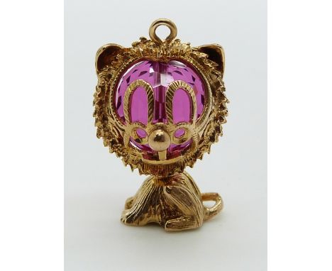 A 9ct gold charm/ pendant in the form of a cat with a pink paste bead to the head, 7.5g